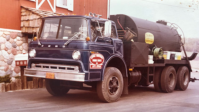 plm-truck-vintage plm sealcoat truck in front of barn vintage