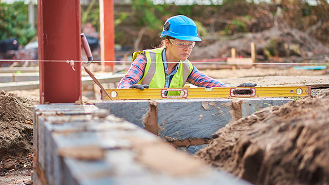 woman-construction-worker-building-concrete-wall